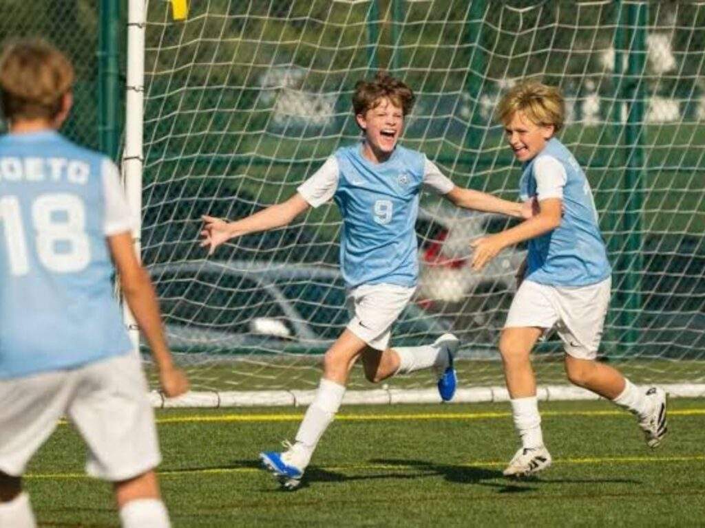 Ted Lasso's son Henry (Grant Feely) celebrates scoring a goal in his soccer game.