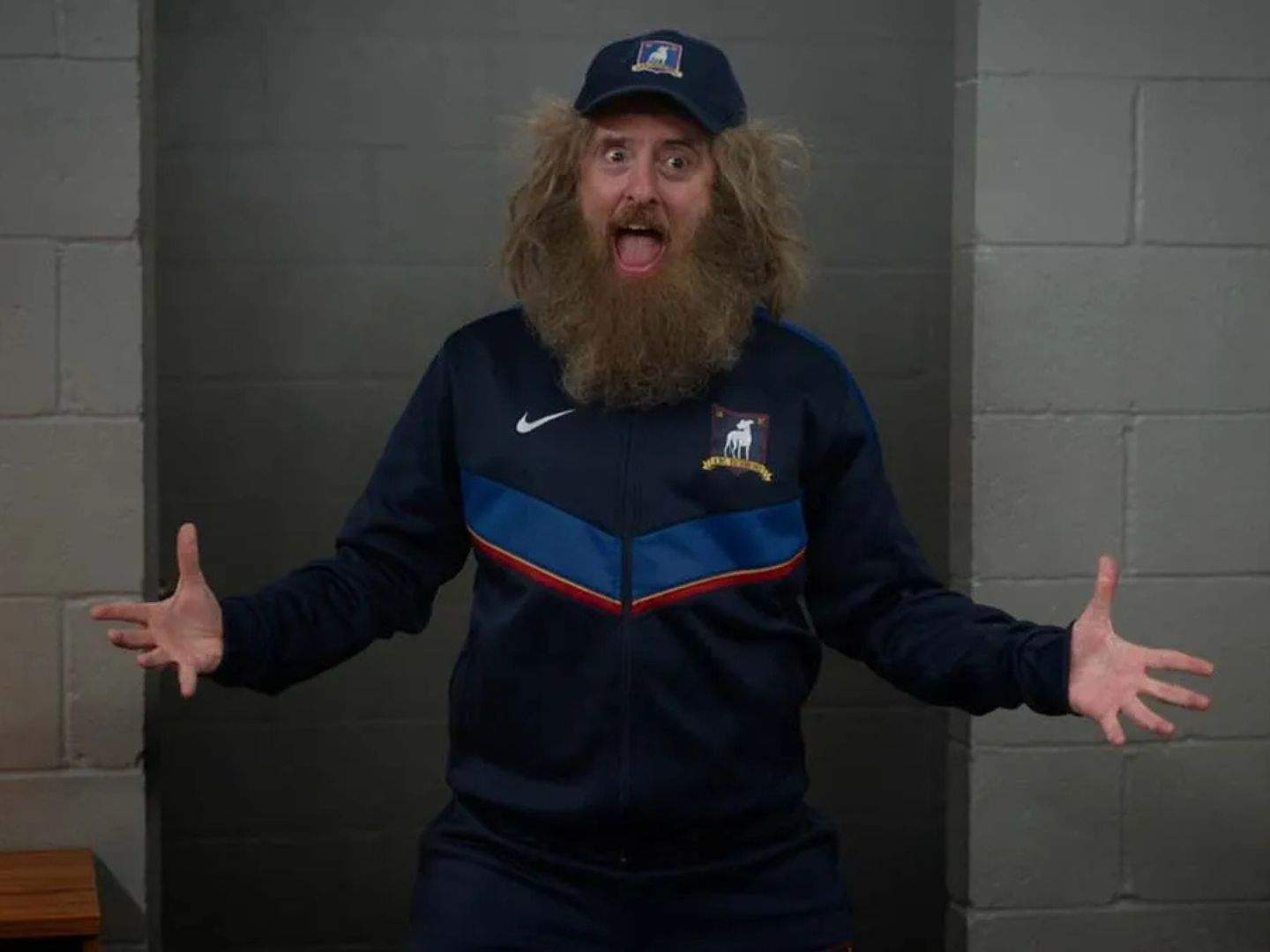 Coach Beard (Brendan Hunt), dressed in his coaching attire and still with his very huge beard, expresses his excitement to join Ted Lasso's (Jason Sudeikis; not pictured) coaching staff again.