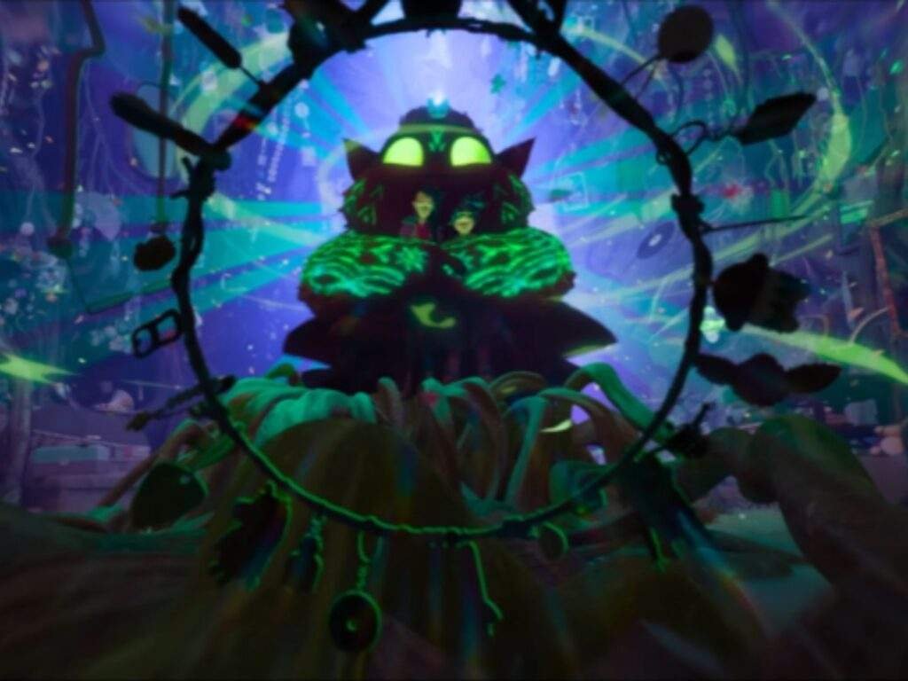 Batiba embraces Jo and Raissa from behind while casting a glowing green memory-erasing spell, surrounding the trio with magical light inside a mysterious, enchanted chamber.