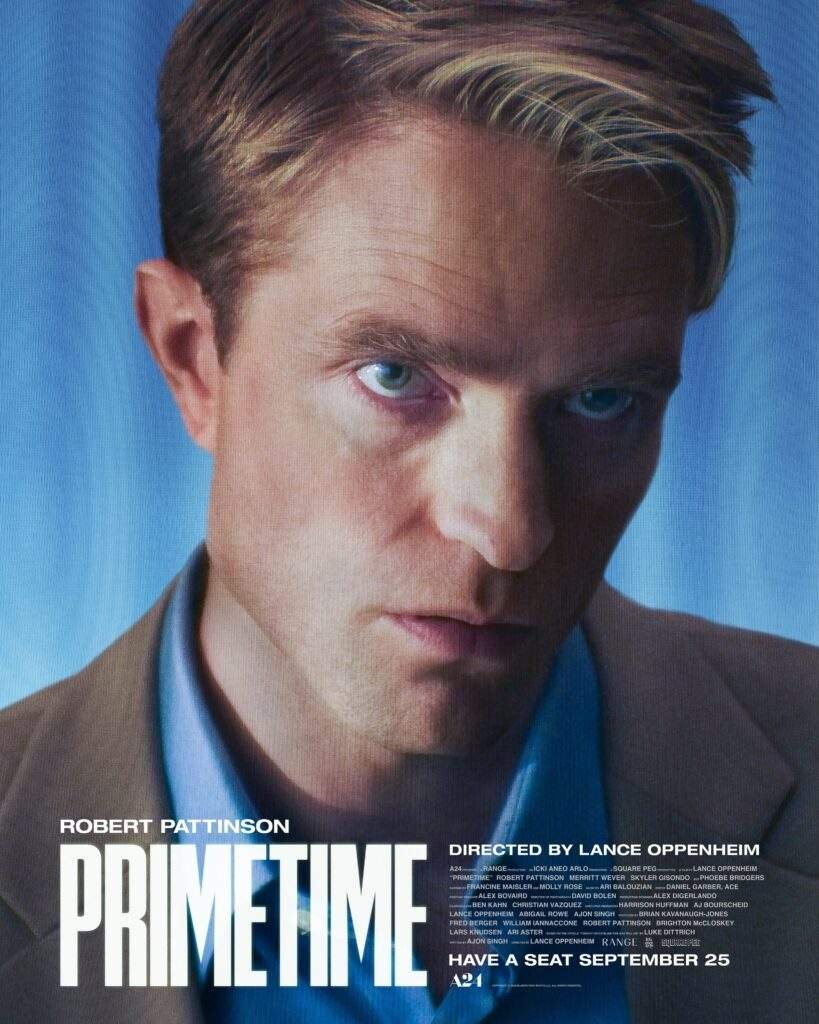 Official poster for Primetime (2026), featuring a close-up of Robert Pattinson as Chris Hansen in a beige suit and blue shirt, staring intensely ahead against a blue background, with the film's title and release date at the bottom.